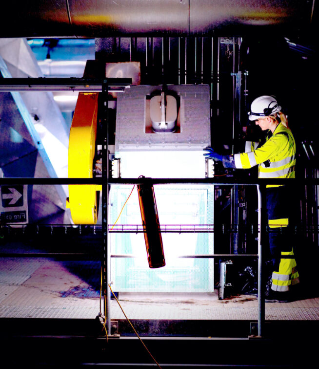 Woman wearing high-vis jacket inside a waste to energy facility